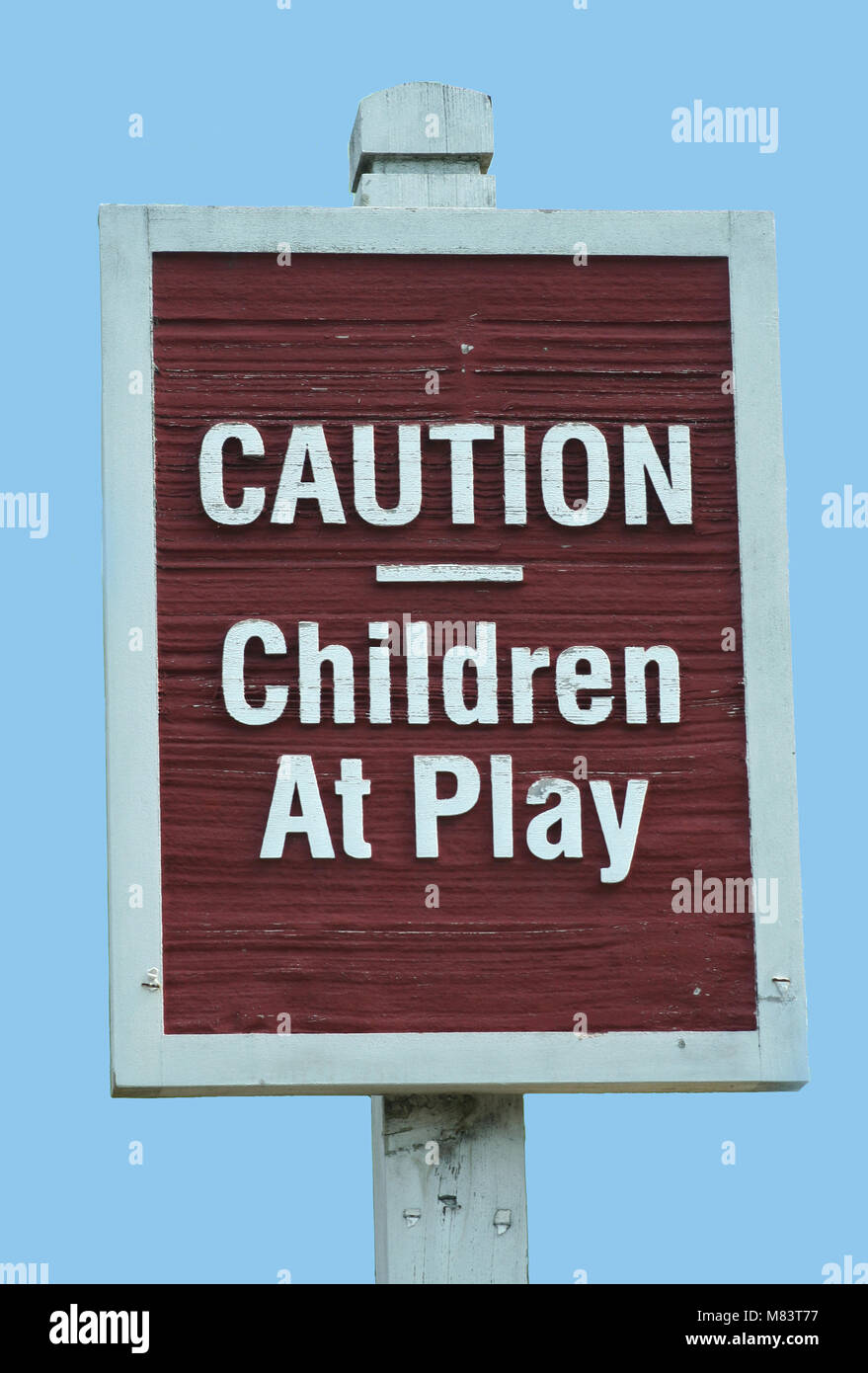 Caution Children at play sign against a blue sky Stock Photo