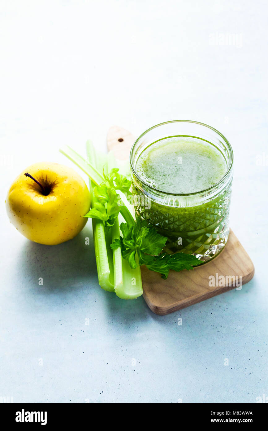 freshly squeezed celery and apple juice in a glass on a wooden small board  on the table. concept and recipe for a healthy diet Stock Photo - Alamy