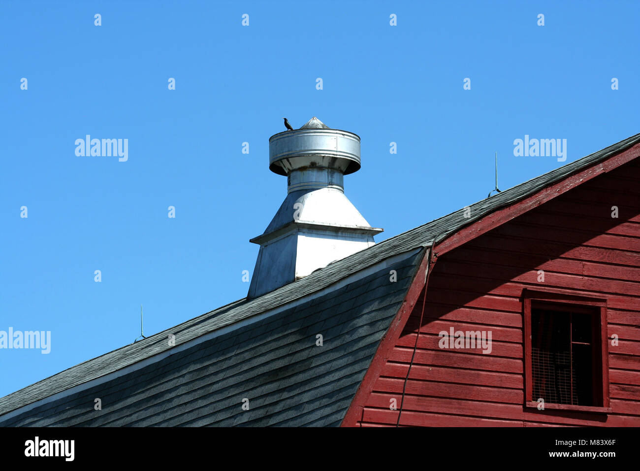 A Barn roof vent against blue sky Stock Photo - Alamy