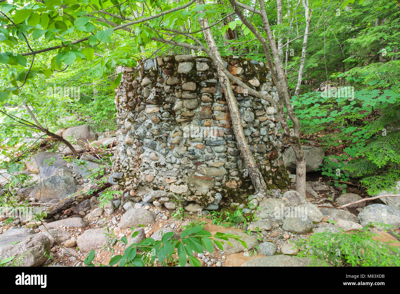 An abandoned stone water holding tank near the old Civilian Conservation Corps camp in Hart’s Location, New Hampshire. The Civilian Conservation Corps Stock Photo