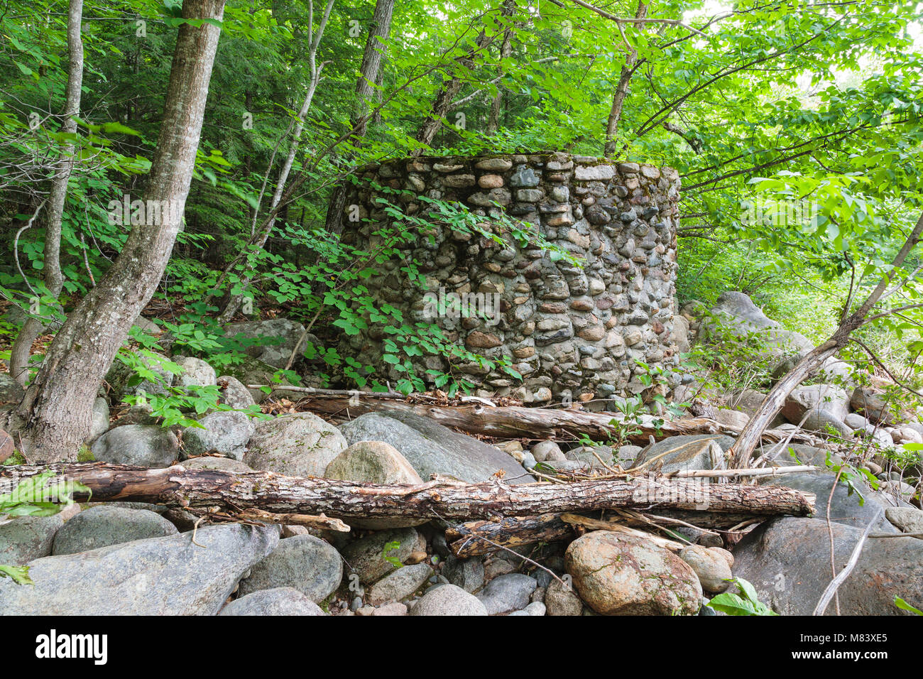 An abandoned stone water holding tank near the old Civilian Conservation Corps camp in Hart’s Location, New Hampshire. The Civilian Conservation Corps Stock Photo