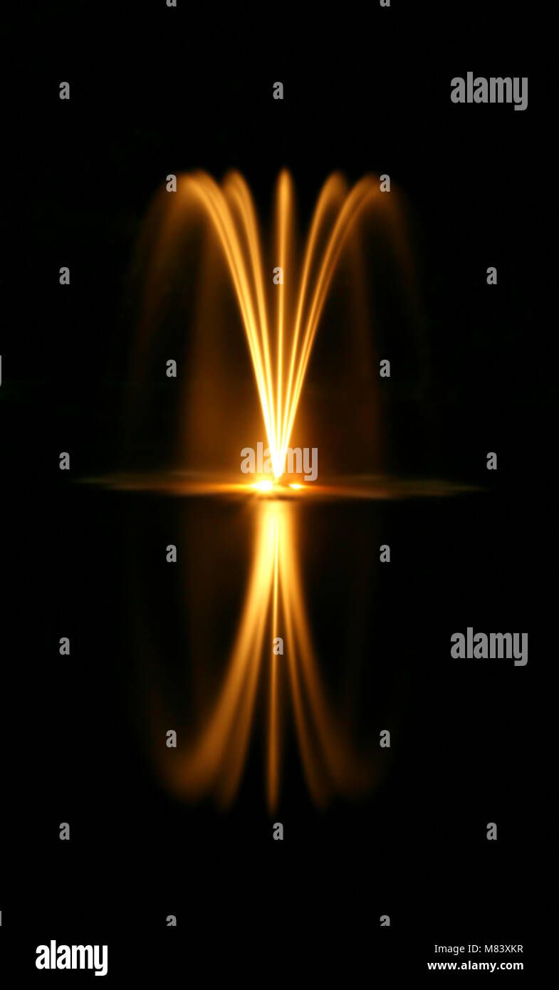A water fountain at night with reflection Stock Photo - Alamy