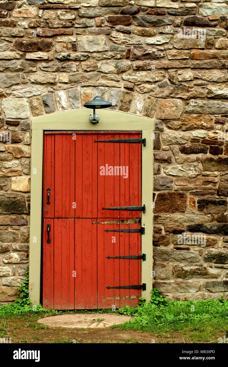 A Red door on a old stone building Stock Photo - Alamy