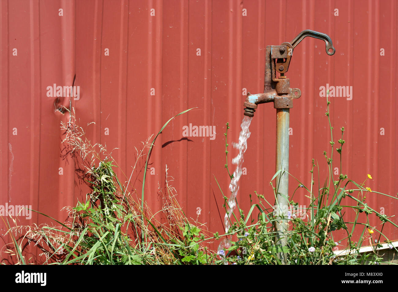 A Old water spigot with running water Stock Photo
