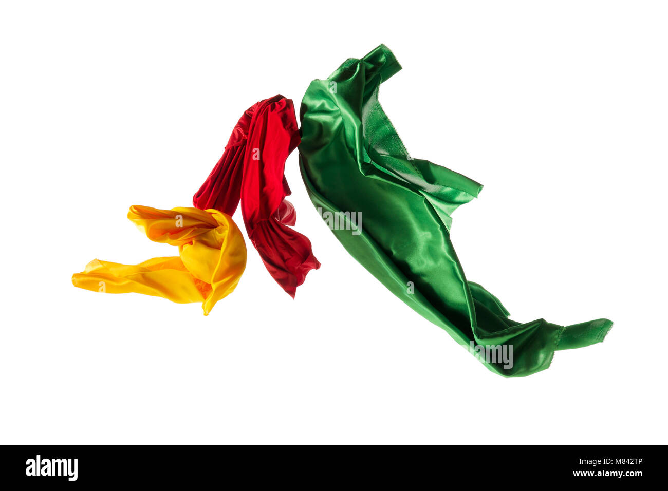 Smooth elegant transparent yellow, red, green cloth separated on white background. Stock Photo