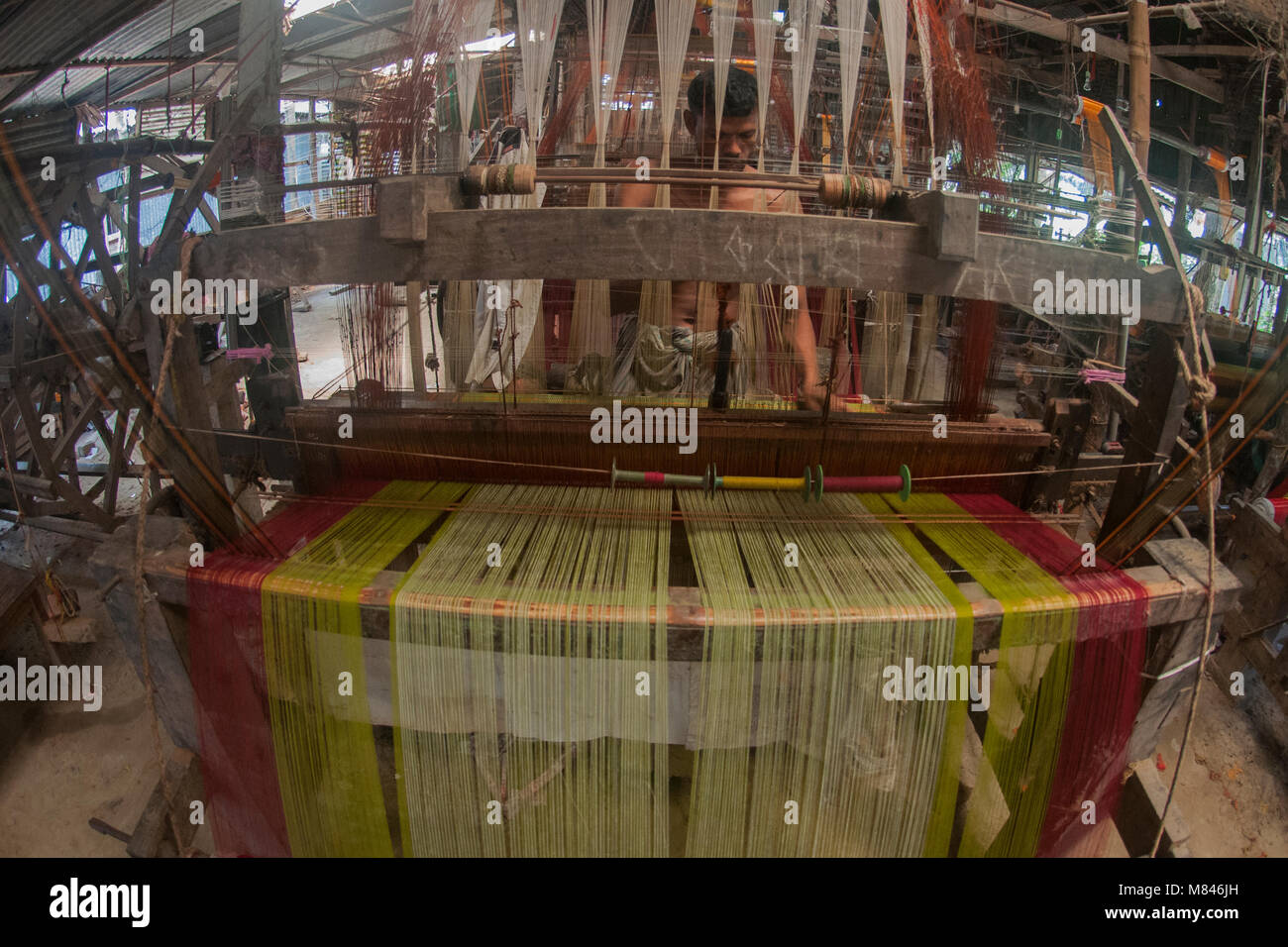 SIRAJANJ, BANGLADESH APRIL 17, 2016 A worker weaves cloth at a