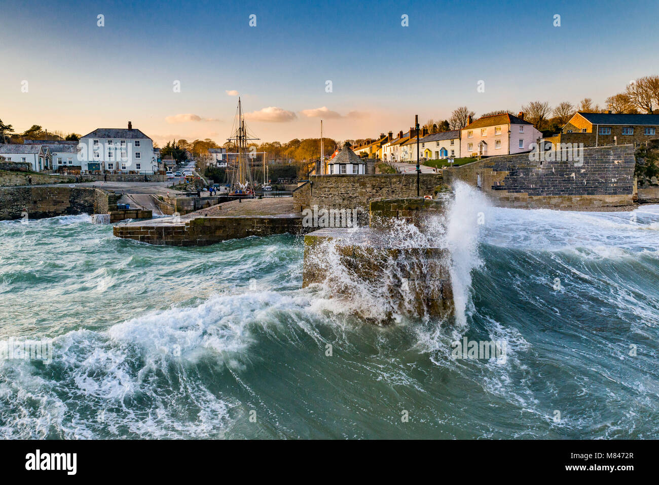Huge waves dwarf the harbour at Charlestown as Storm Emma makes landfall. Storm Emma brought deep ocean swells as well as high winds and snow. Stock Photo