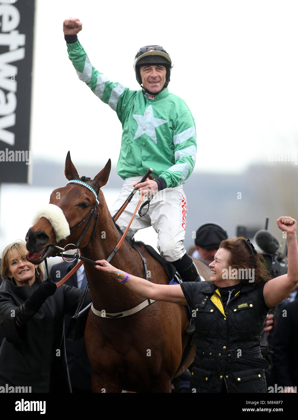 Jockey Davy Russell (centre) celebrates winning the RSA Insurance ...