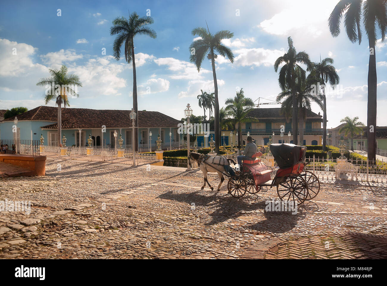 The central square of the historic center of Trinidad with a carriage in the foreground. Stock Photo