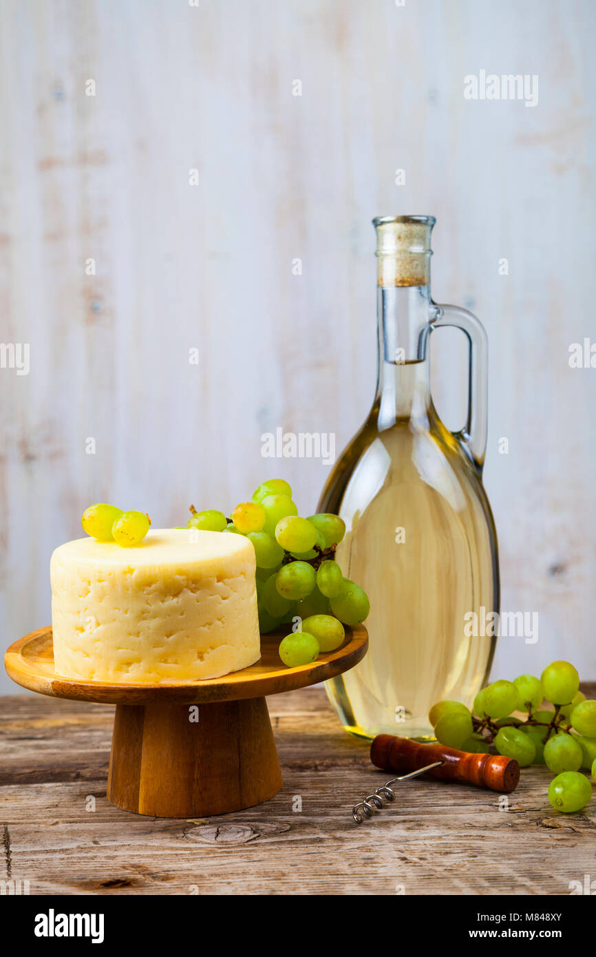 Traditional tete de moine aged mountain cheese of the Alps served with  grapes and walnuts wooden design board with copy space Stock Photo - Alamy