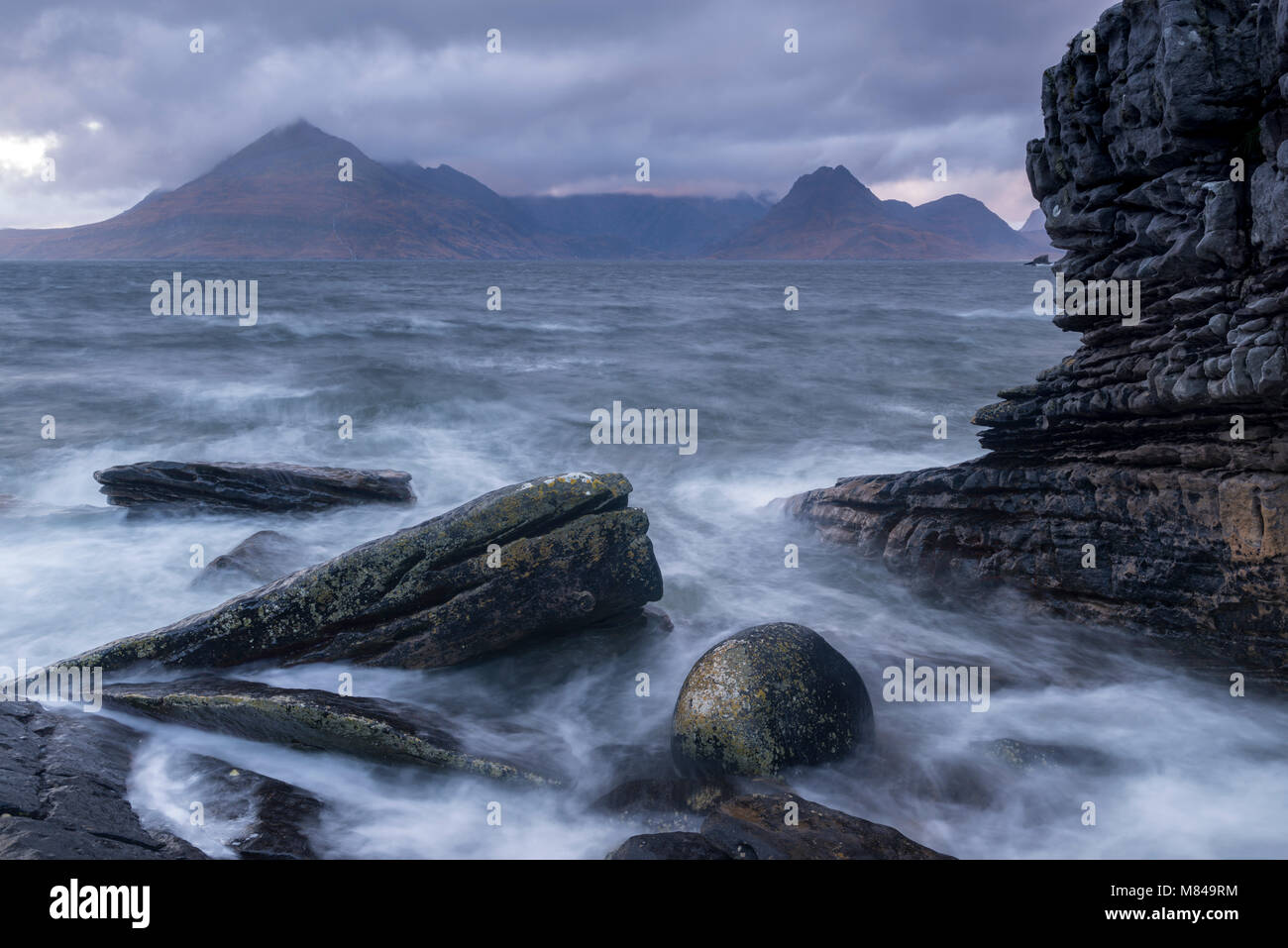 The Cuillin mountains from the rocky seashore at Elgol, Isle of Skye, Scotland. Autumn (November) 2017. Stock Photo