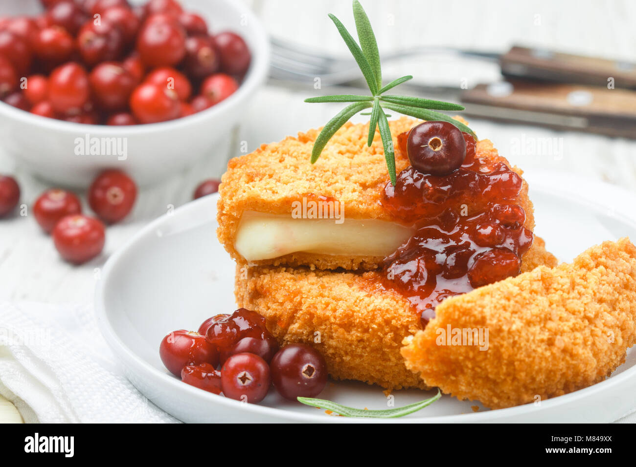 Baked breaded Camembert cheese (brie) with fresh berries and cranberry