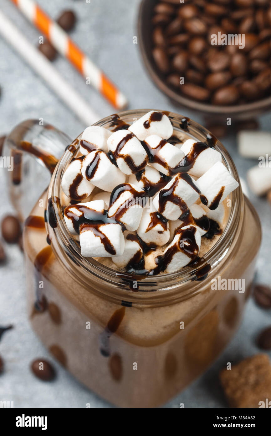 Chocolate frappe coffee with marshmallows and syrup in a Mason jar . Selective focus Stock Photo
