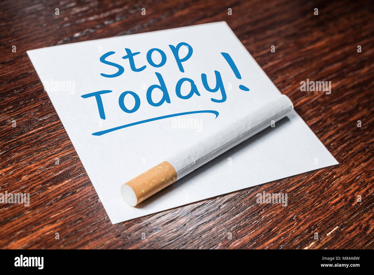 Stop Smoking Today Reminder With Cigarette On Wooden Shelf Stock Photo -  Alamy