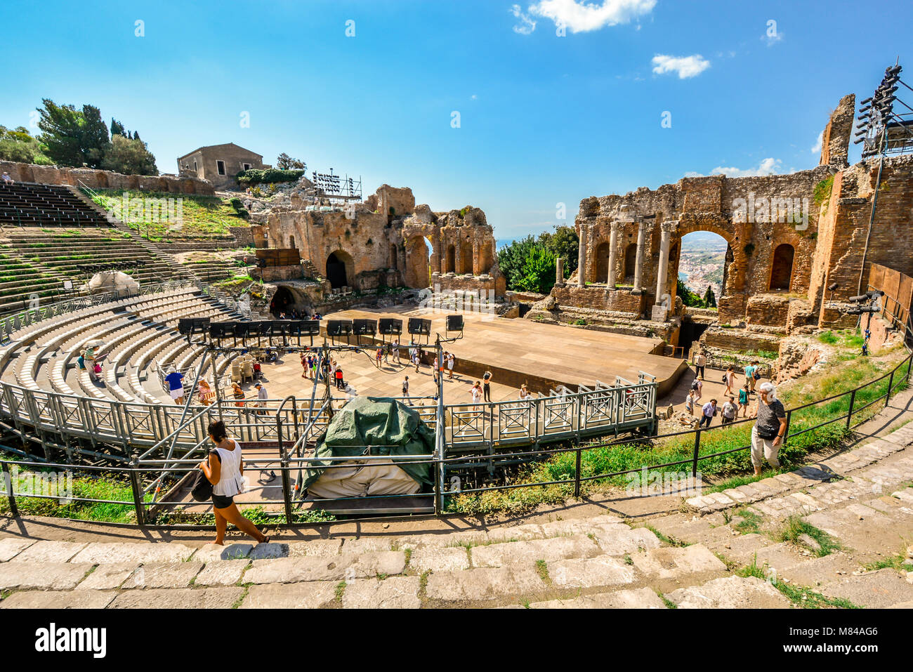 The ancient Greek Theatre on the island of Sicily, city of Taormina Italy on a summer day with tourists Stock Photo