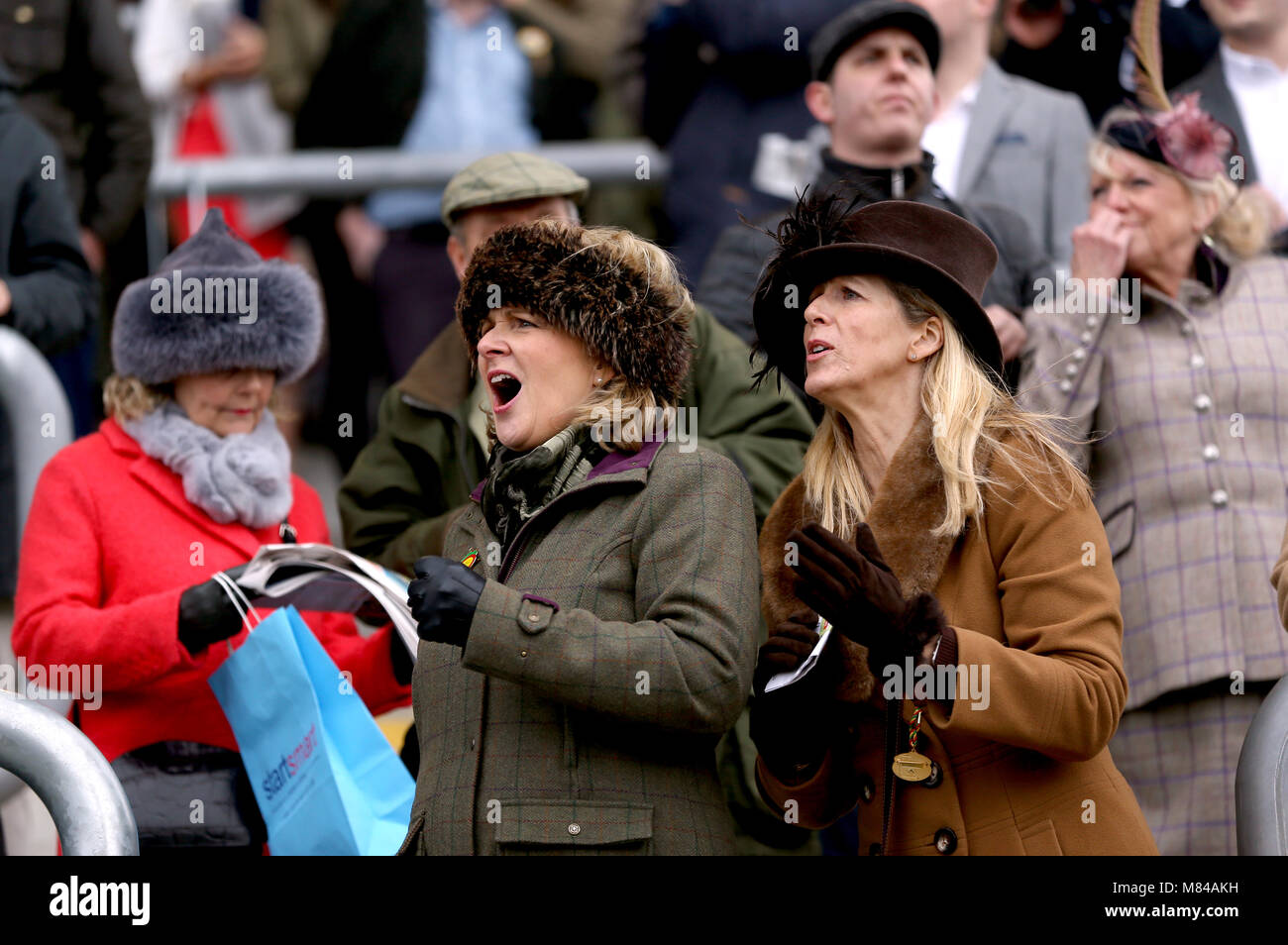 Female racegoers react during Ladies Day of the 2018 Cheltenham Festival at Cheltenham Racecourse. Stock Photo