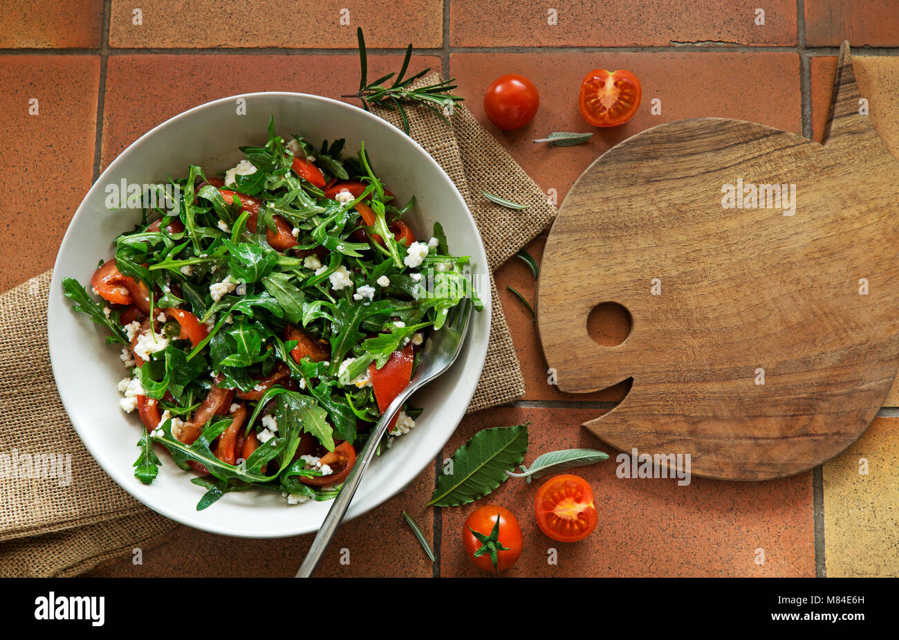 Rocket Salad with arugola tomato and cheese on background. Stock Photo