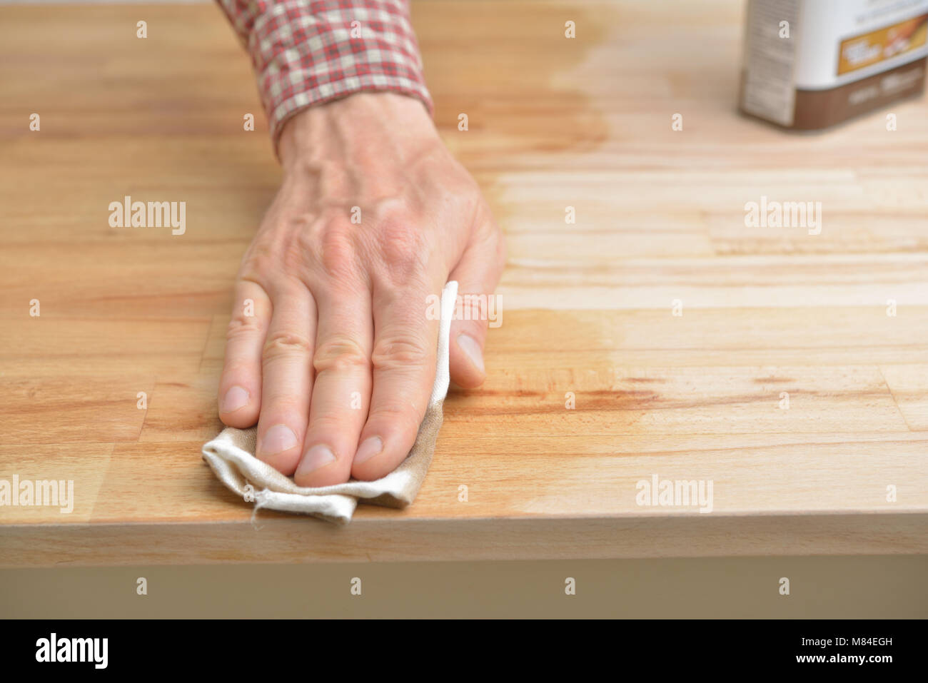 Man applying the Danish oil to the beech wood Stock Photo Alamy