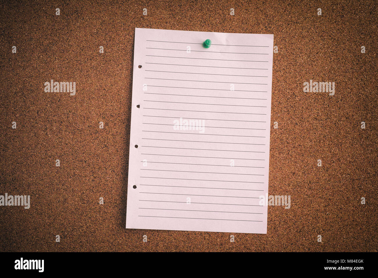 Blank lined paper sheet on bulletin board. Close up. Stock Photo
