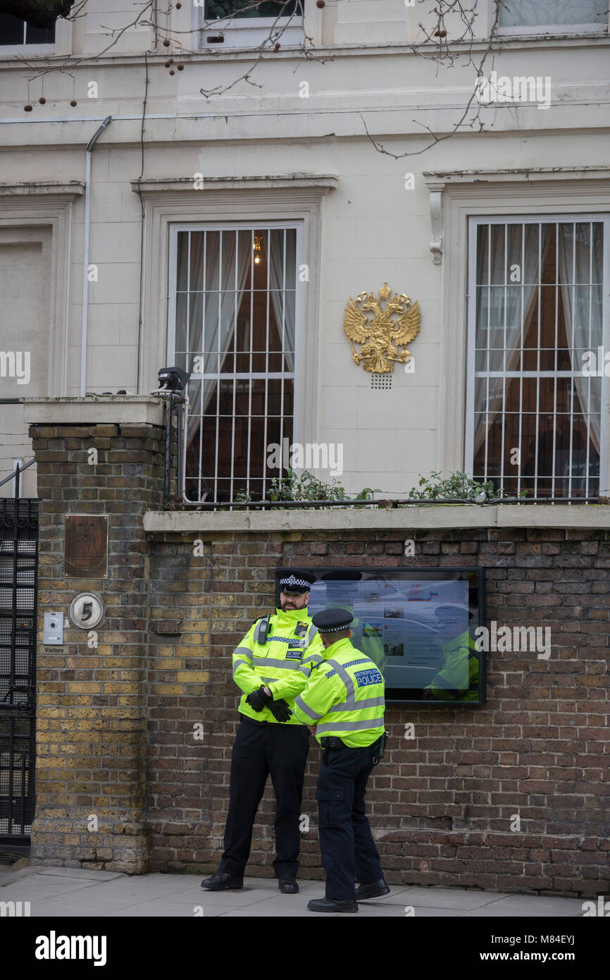 On the day that the British government awaits an explanation from the Kremlin over the poisoning by the nerve gas Novichok in Salisbury of ex-Russian spy Sergei Skripal and his daughter Yulia, Metropolitan police officers stand outside the Russian Federation Embassy and Consulate Section, on 13th March 2018, in London England. Stock Photo