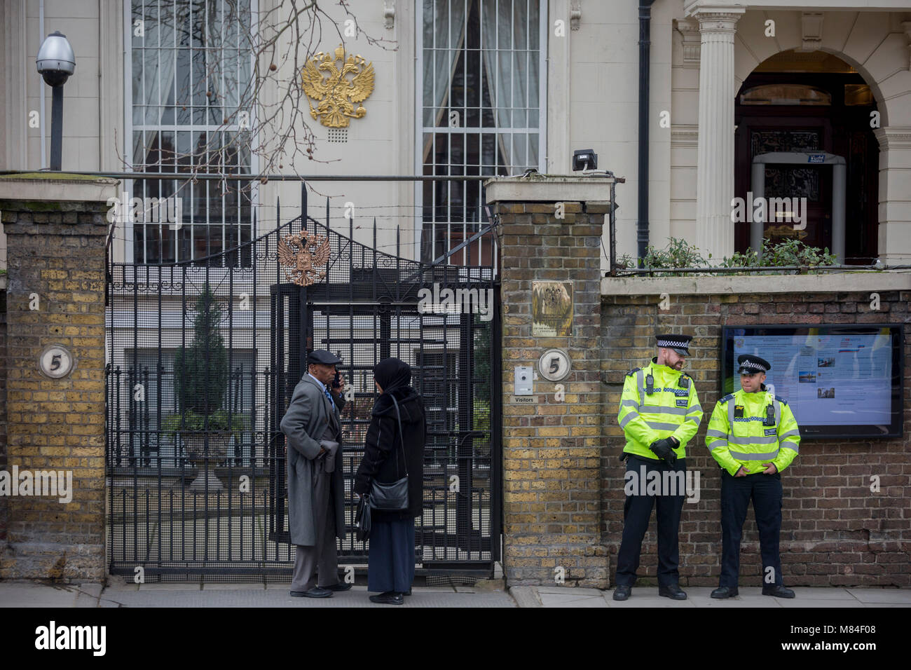 On the day that the British government awaits an explanation from the Kremlin over the poisoning by the nerve gas Novichok in Salisbury of ex-Russian spy Sergei Skripal and his daughter Yulia, Metropolitan police officers stand outside the Russian Federation Embassy and Consulate Section, on 13th March 2018, in London England. Stock Photo