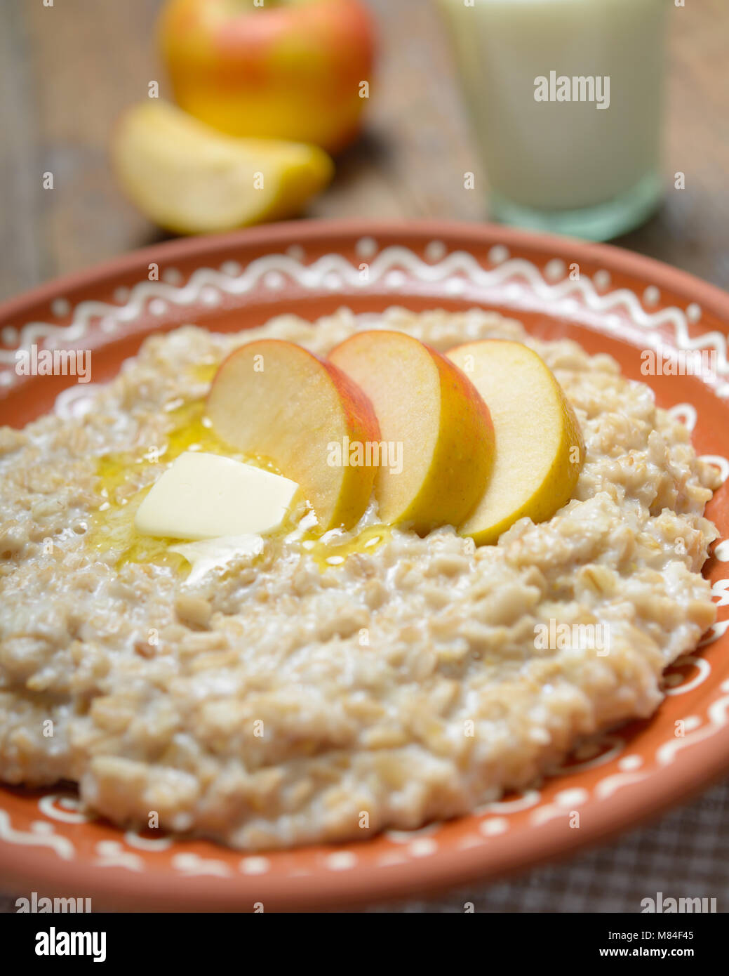 Oatmeal porridge with butter and apples Stock Photo