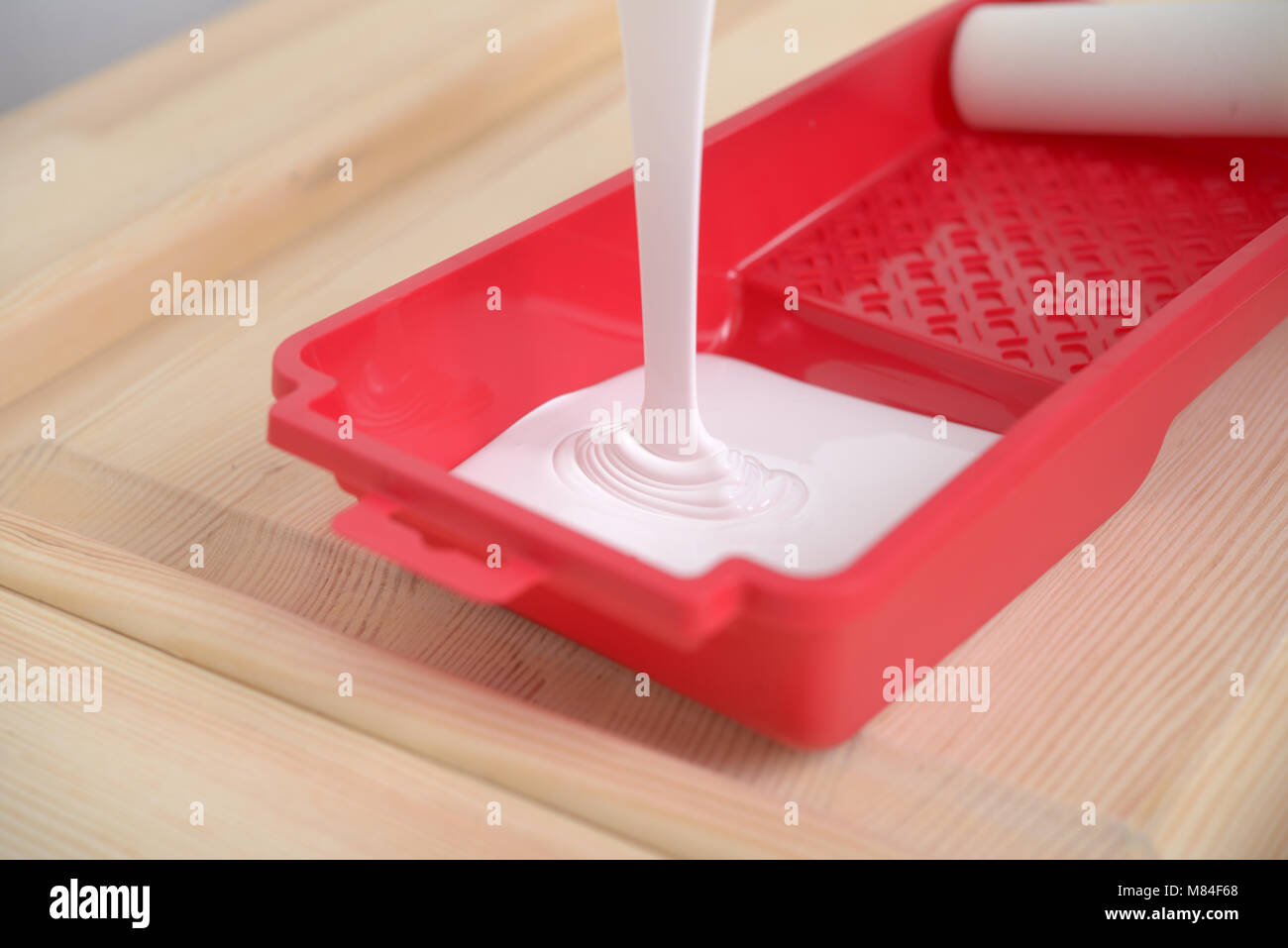 Pouring a paint into a painting tray Stock Photo Alamy