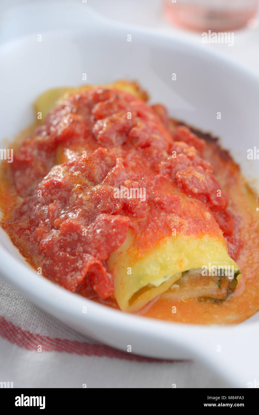 Cannelloni with spinach and ricotta under tomato sauce Stock Photo