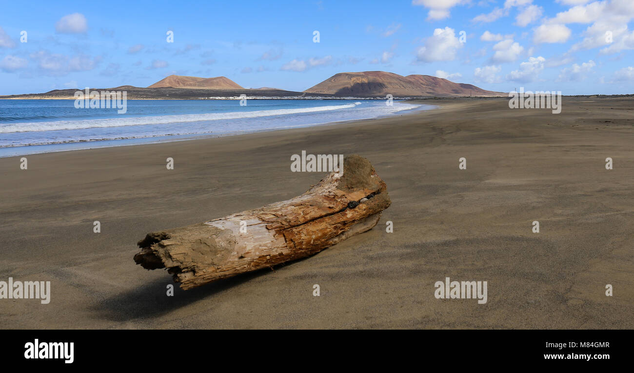 Graciosa, seen from Lanzarote, log on beach Stock Photo