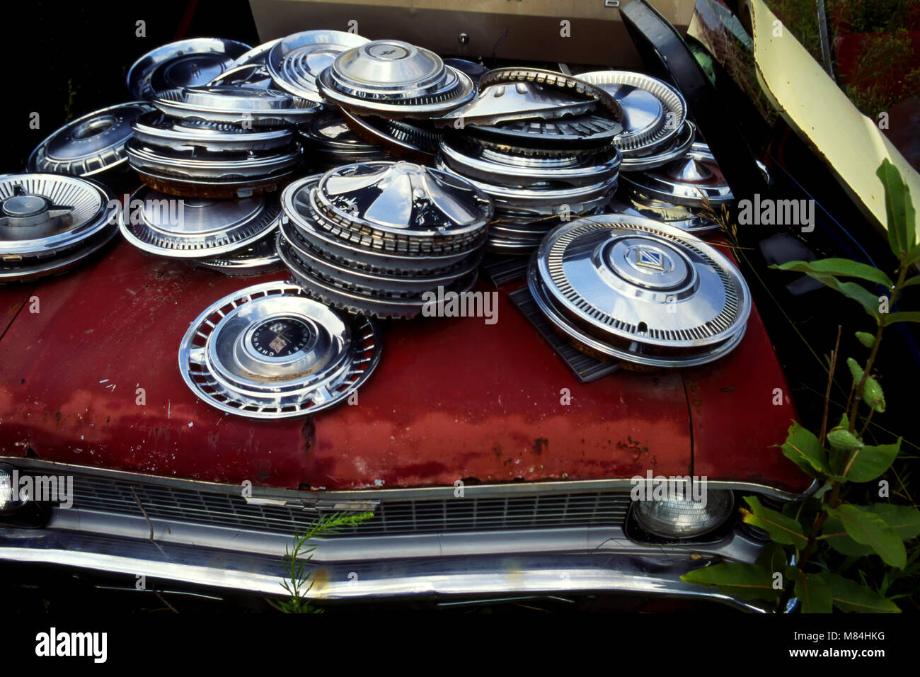 Hubcaps in pile at junkyard Stock Photo - Alamy