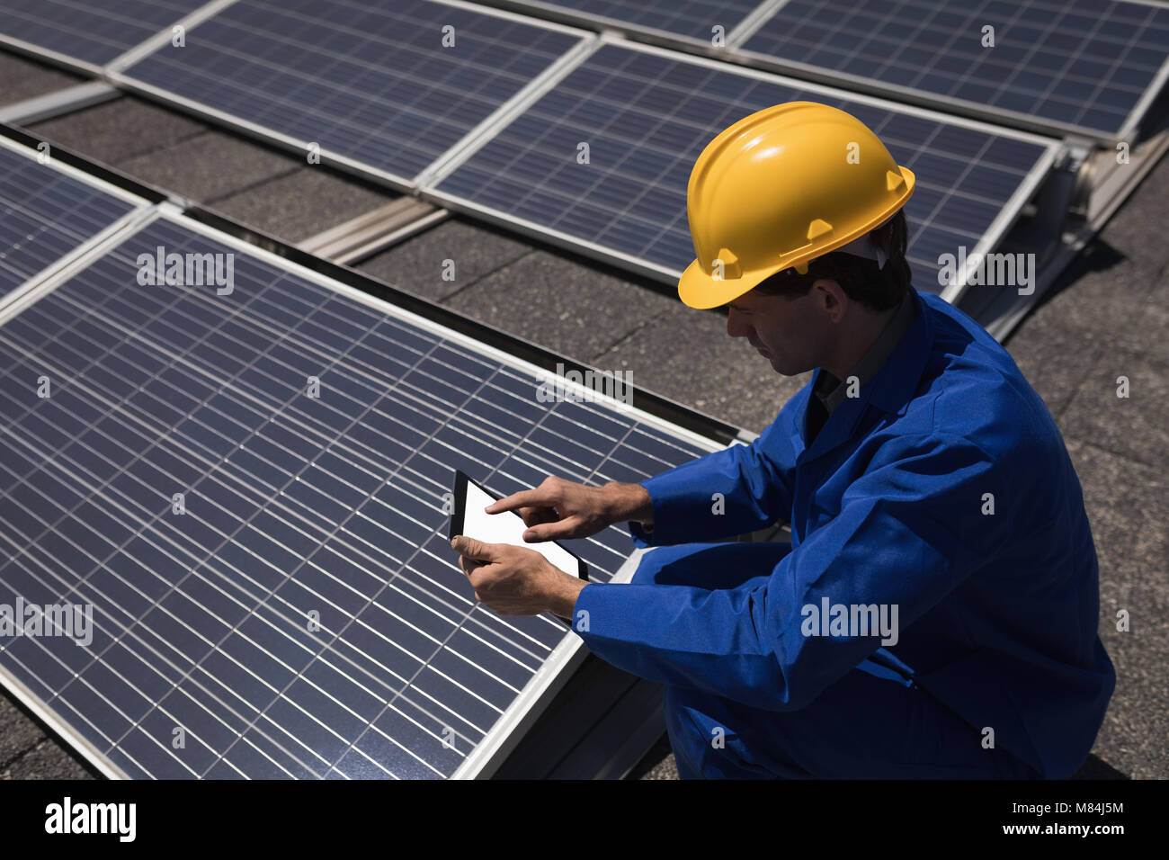 Male worker using digital tablet at solar station Stock Photo