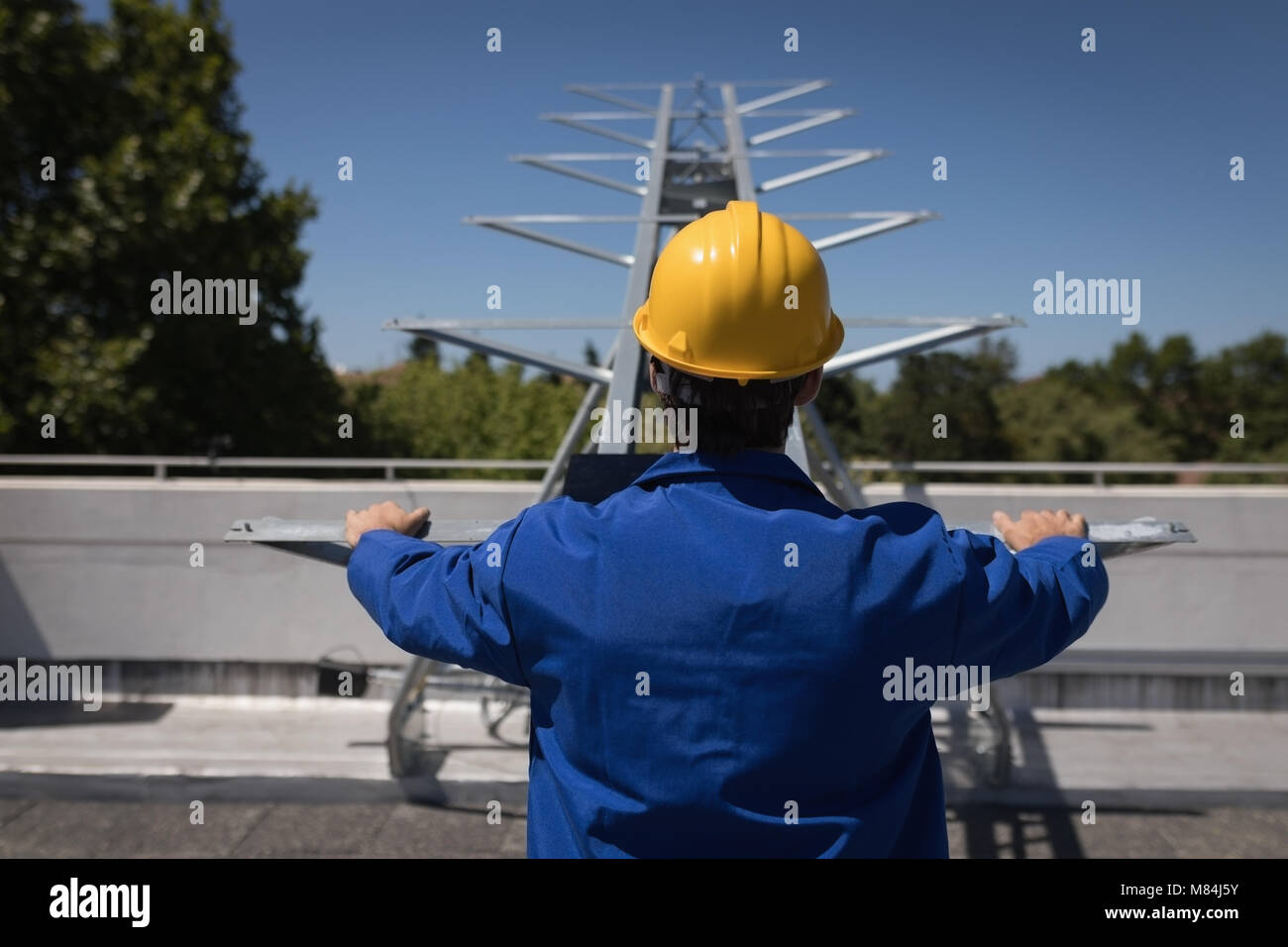 Male worker using machine at solar station Stock Photo