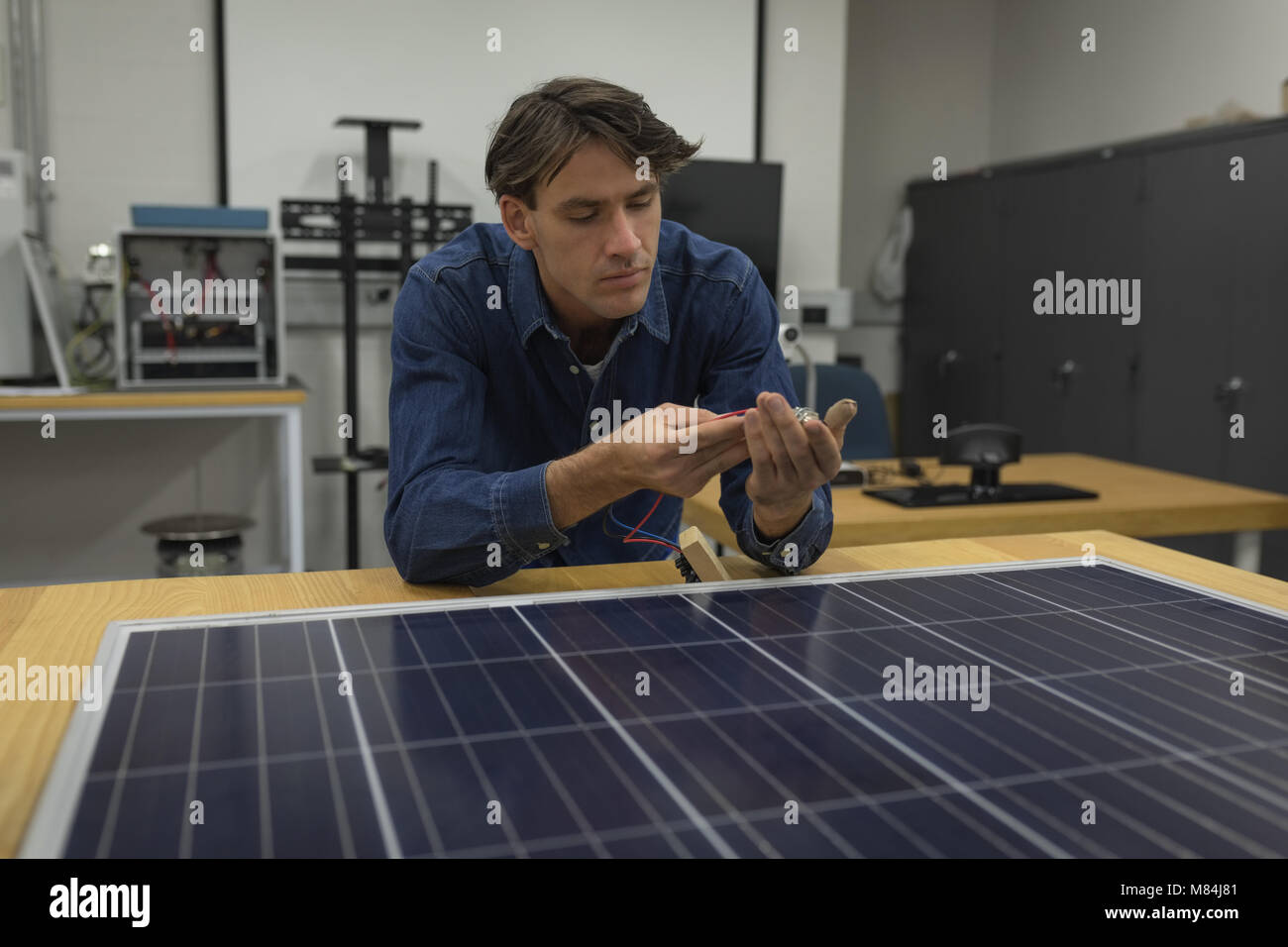 Male worker working on solar panel Stock Photo