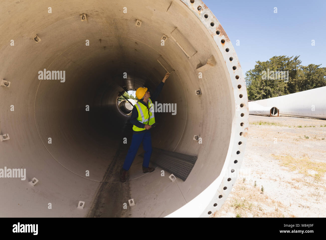 Male worker examining a concrete tunnel Stock Photo