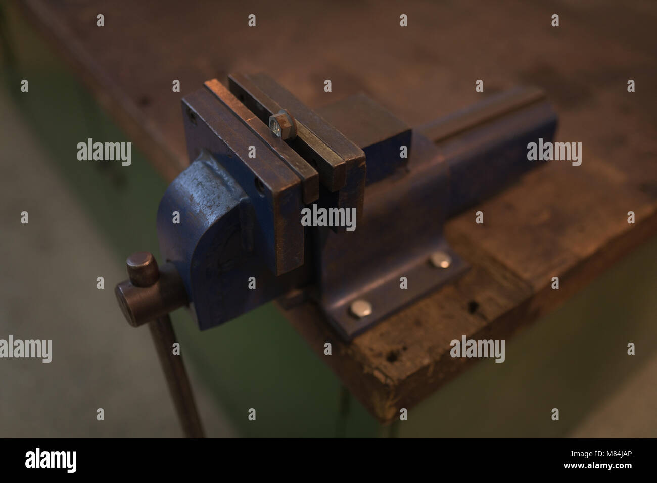 Vise tool on a wooden table Stock Photo