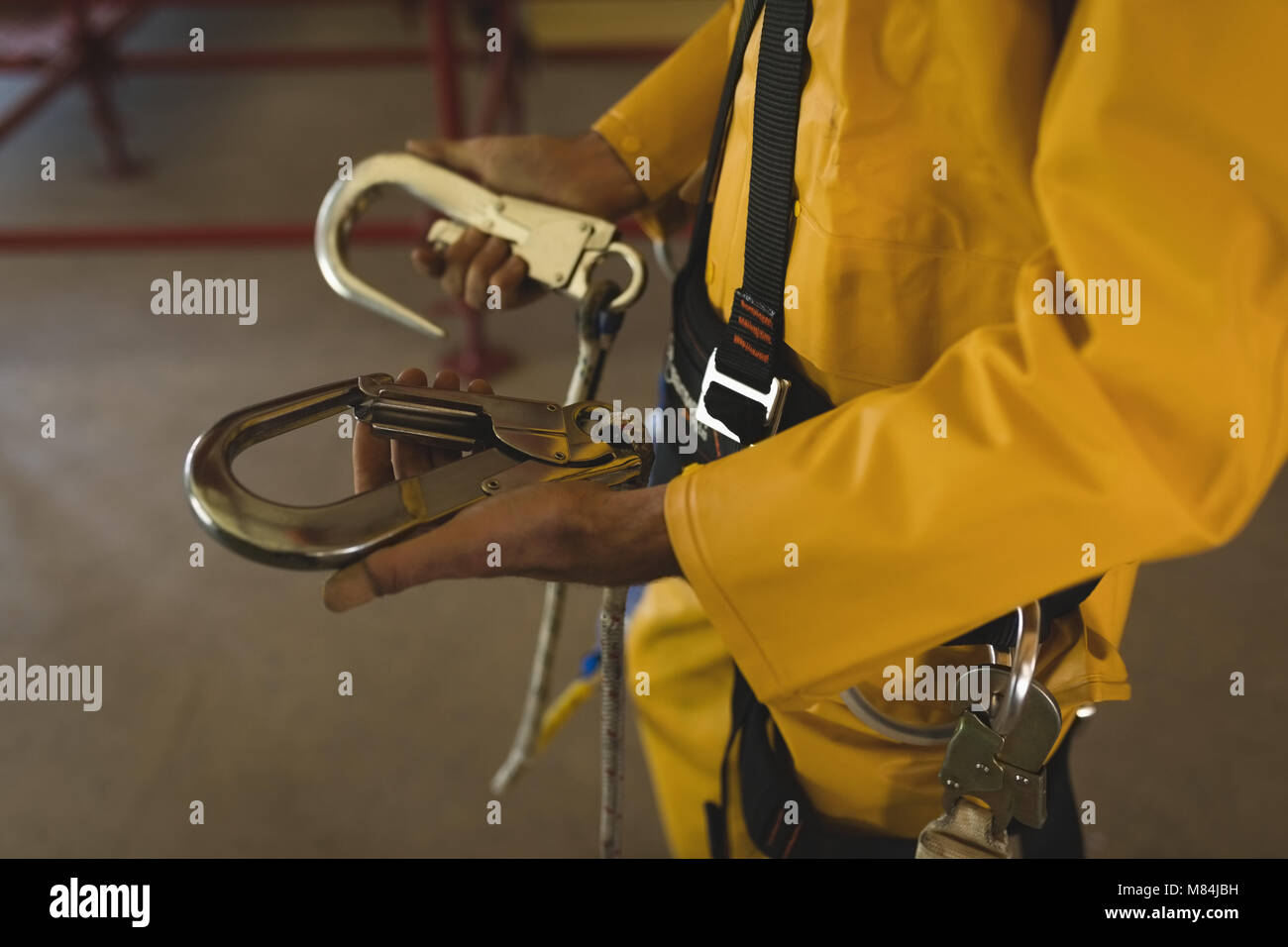 Male worker holding carabiner at solar station Stock Photo