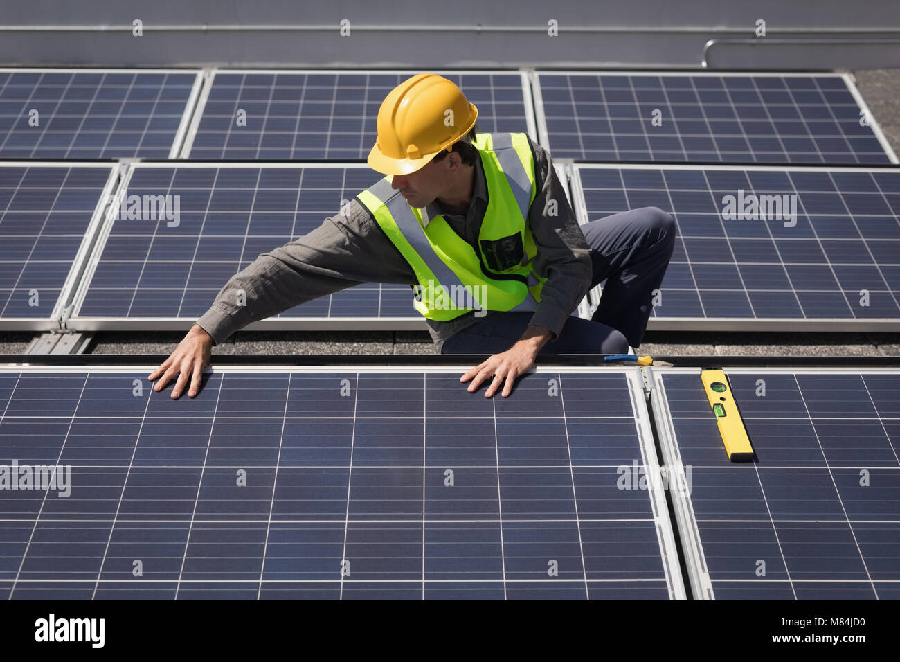 Male worker working on solar panels at solar station Stock Photo