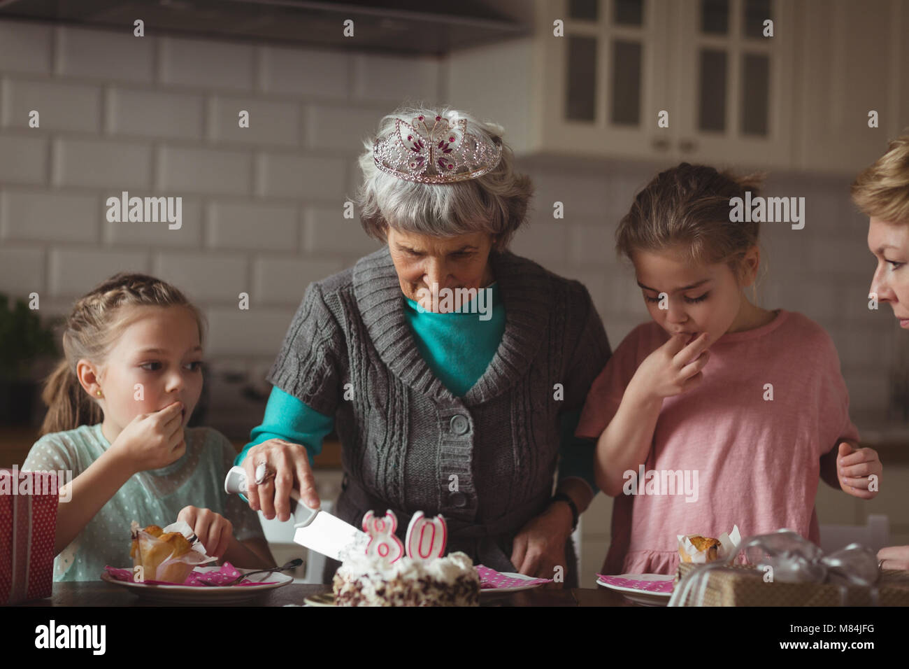 Grandmother celebrating her birthday with her family Stock Photo
