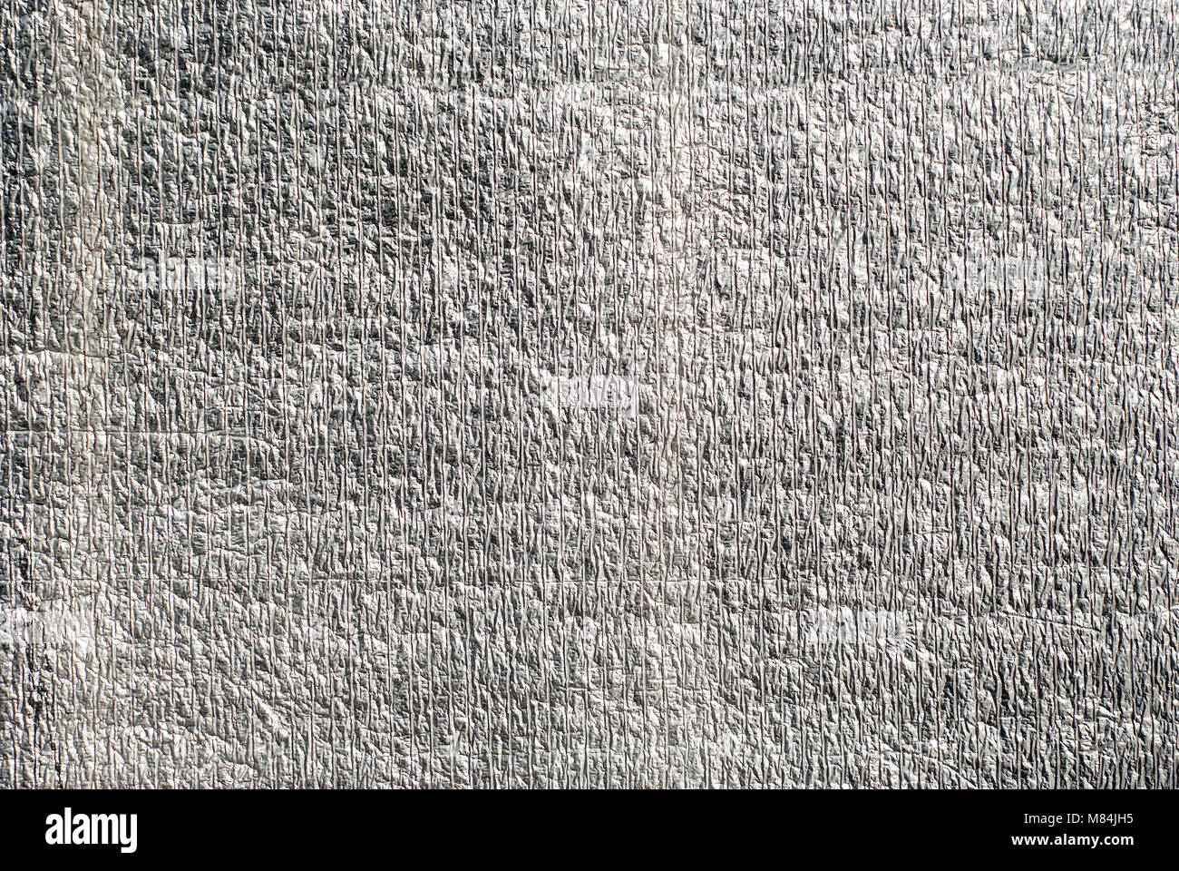 background, texture - silvery wrinkled surface of heat-insulating foil Stock Photo