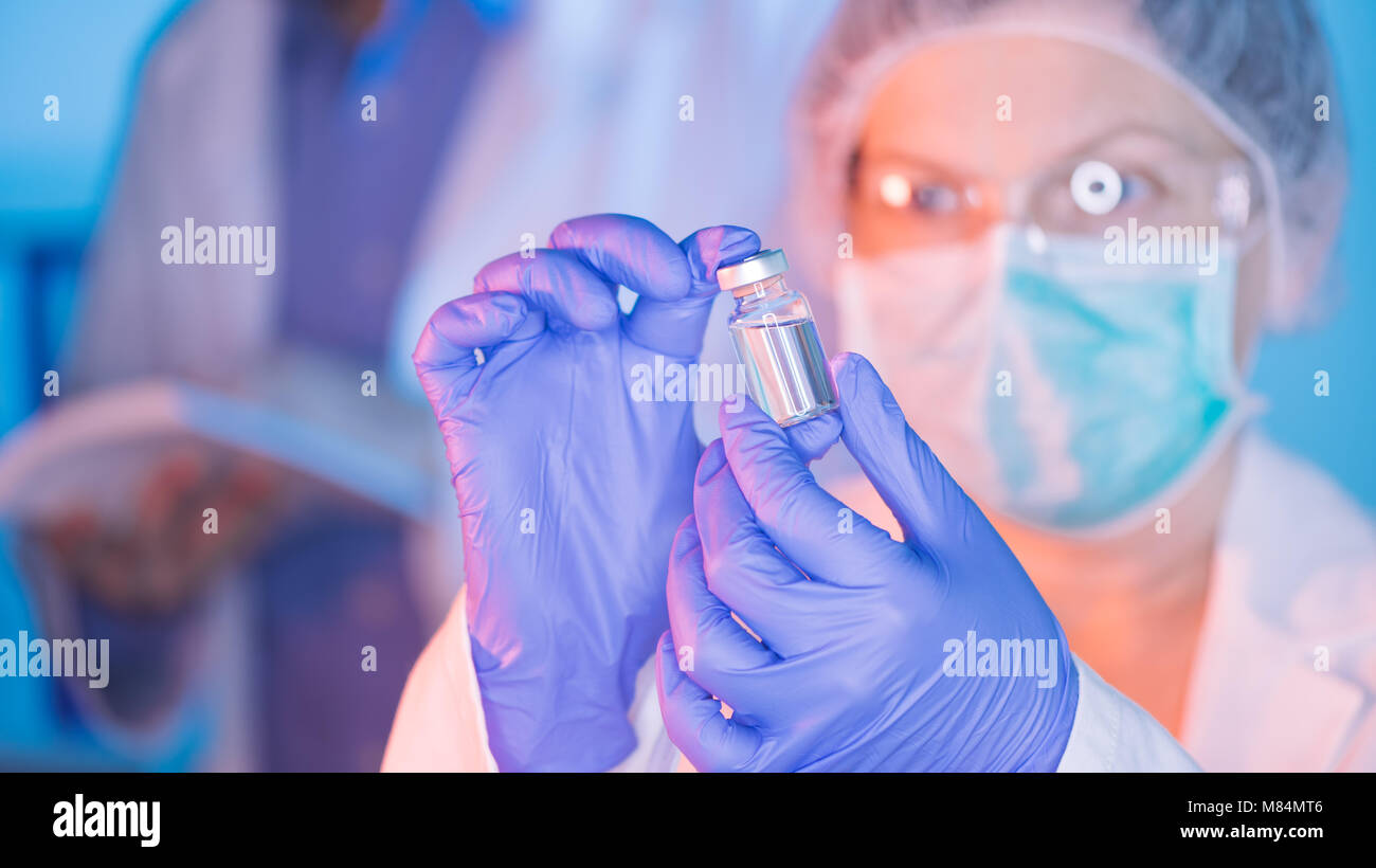 Doctor and nurse analyzing unknown MMR vaccine in medical clinic hospital Stock Photo
