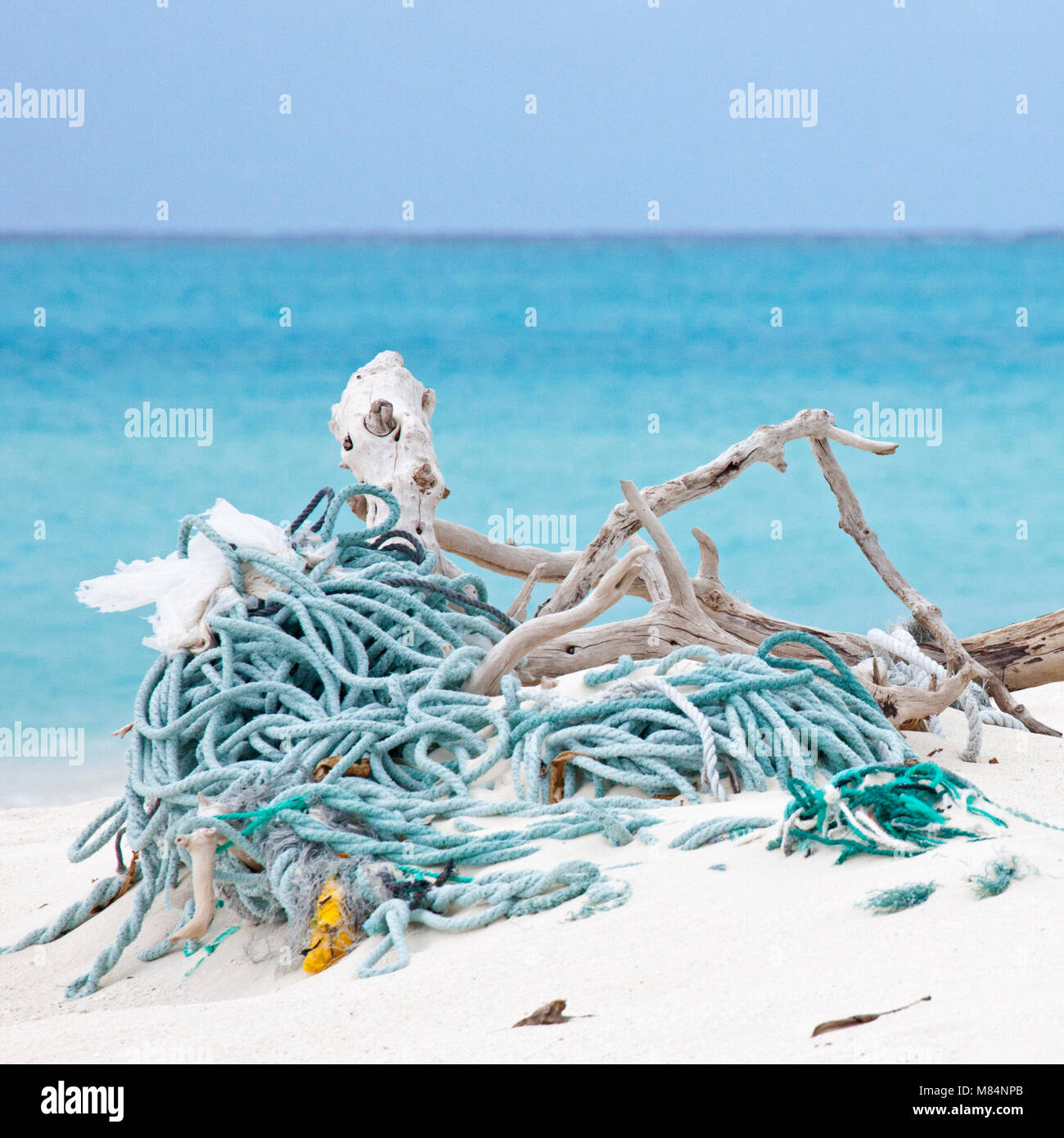 Ropes and nets at water edge after being washed ashore by ocean currents on a North Pacific island Stock Photo