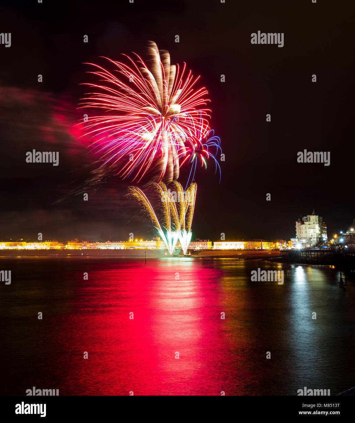 Fireworks display reflected on the sea beside the Grand Hotel on Guy Fawkes night at Llandudno, Wales, UK. Stock Photo