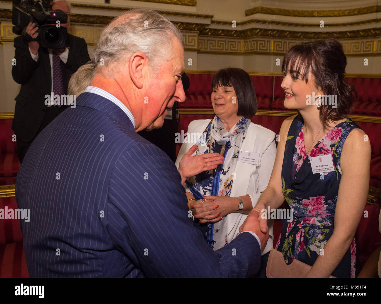 The Prince of Wales meets Royal College of Nursing Student Nurse of the Year Zoe Butler (right) and Elaine Perry of Macmillan Cancer Support at a reception to celebrate frontline nursing in the UK at Buckingham Palace in London. Stock Photo