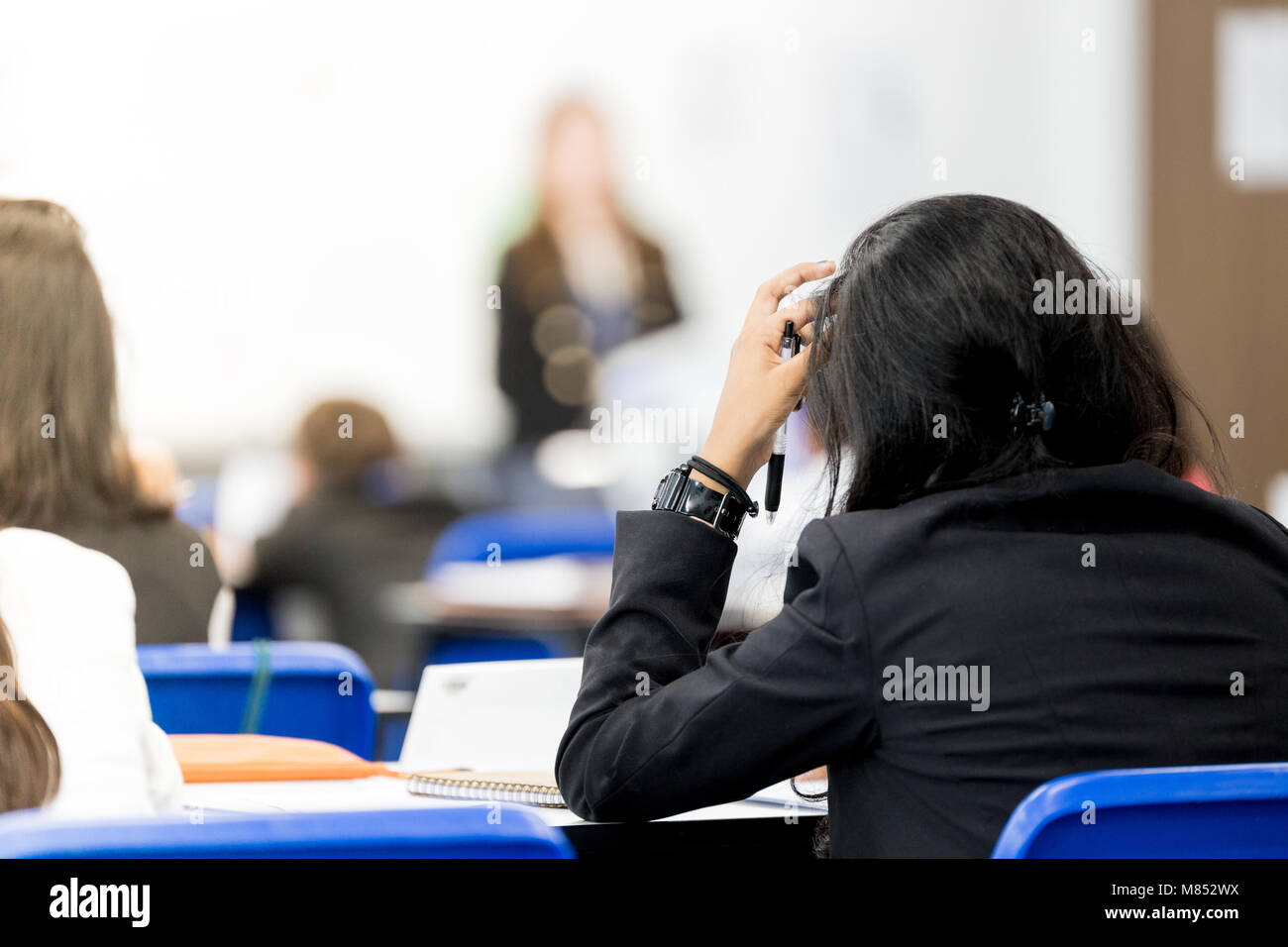 Student studying hard in class Stock Photo