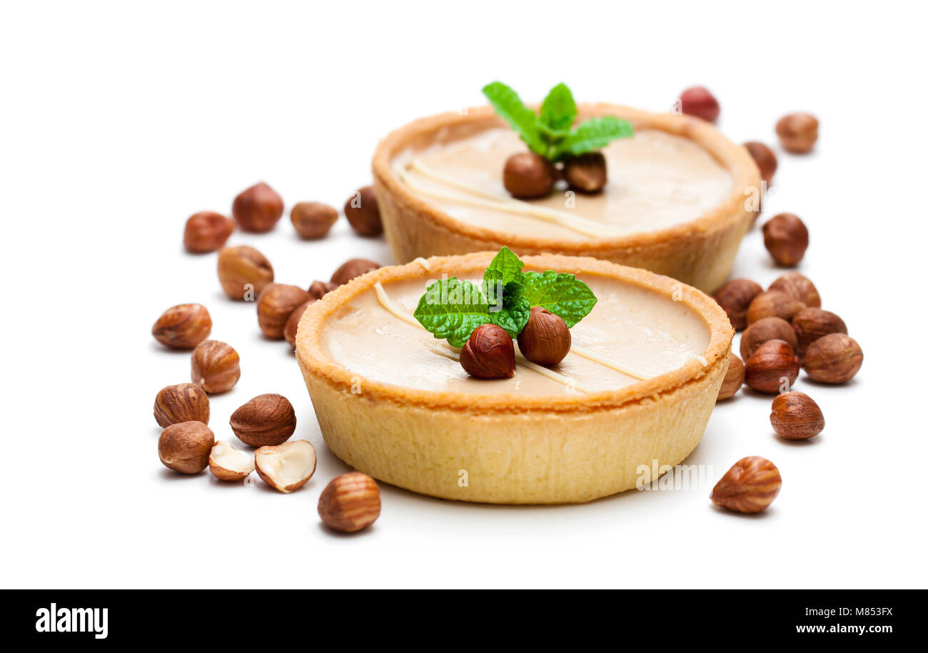 mini hazelnut and chocolate tarts isolated on white background Stock