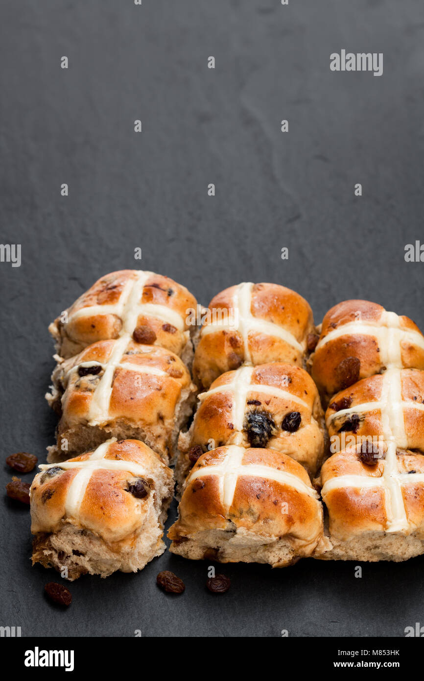 Easter  cross buns and sultanas on black stone background Stock Photo