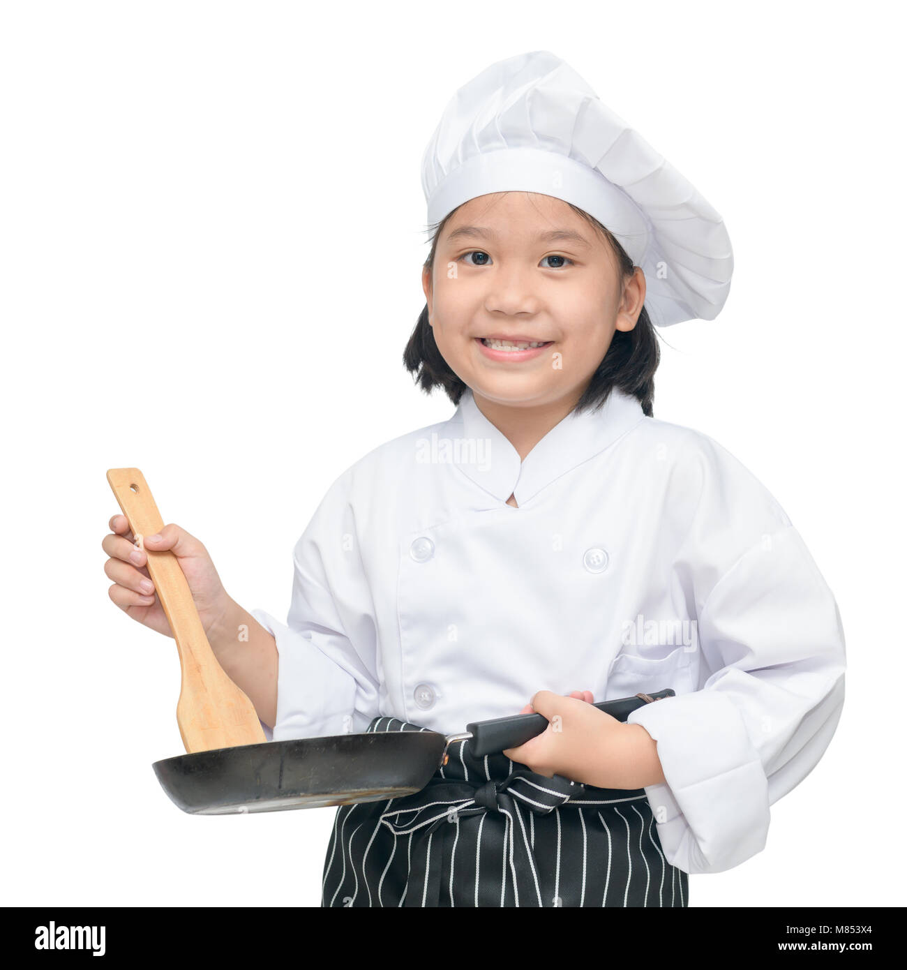 Happy asian girl chef holding cooking utensils and smile isolated on white background Stock Photo