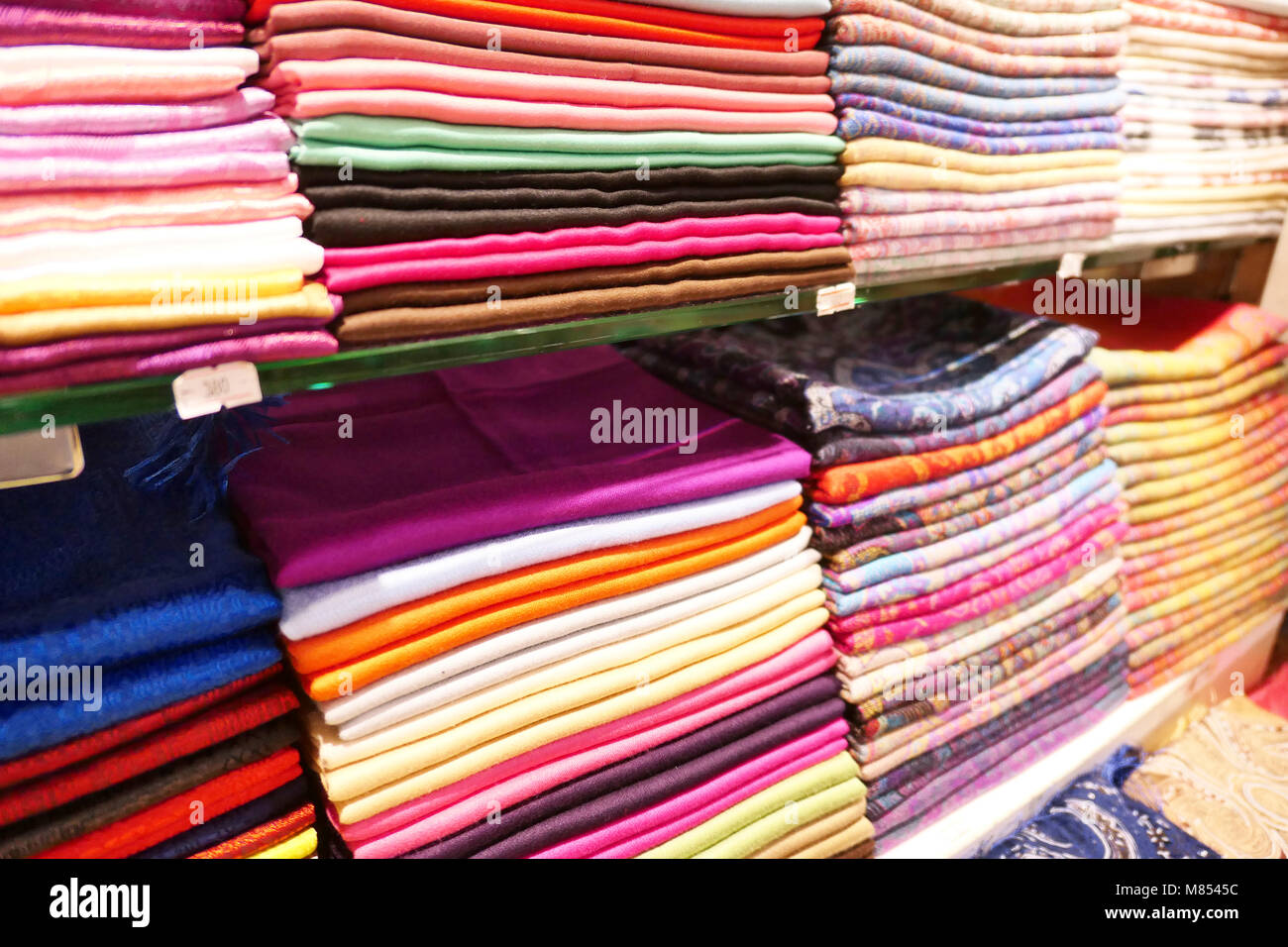Stacks of colorful headscarfs and textile Stock Photo