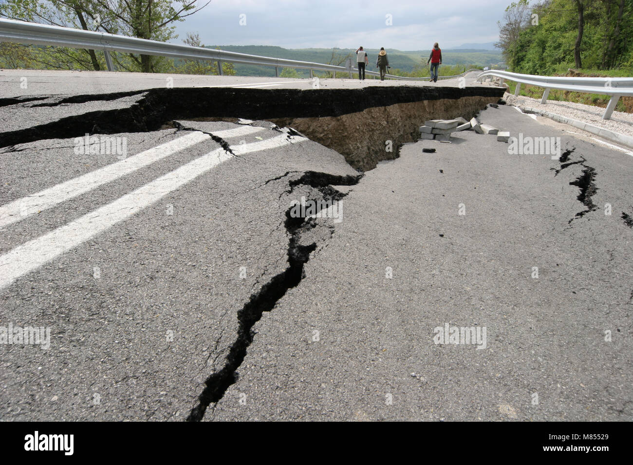 Road collapses with huge cracks. International road collapsed down