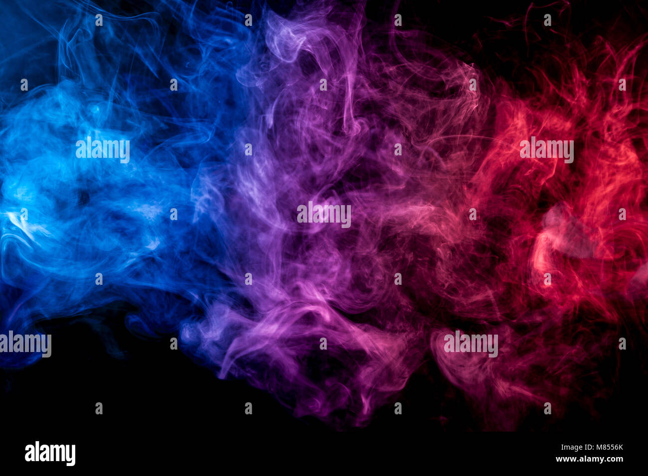Dense Multicolored Smoke Of Blue Red And Purple Colors On A Black